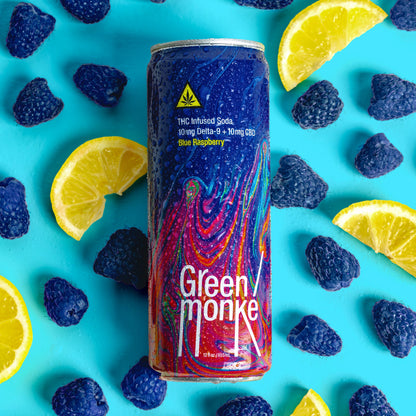 Green Monké Blue Raspberry soda can with fresh berries and lemon