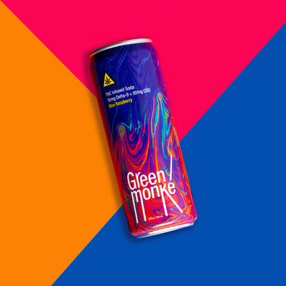 Green Monké Blue Raspberry soda can on a bold colorblock background