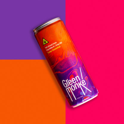 Green Monké Orange Passionfruit THC soda can on a bold colorblock background